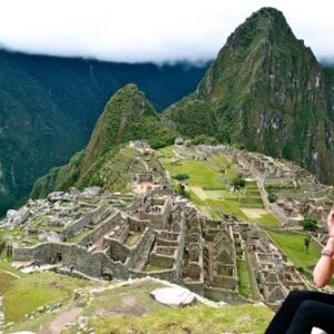 Tourist seated with Machu Picchu in the background